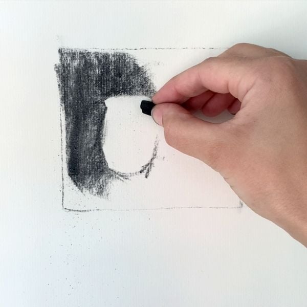 artist drawing with charcoal for value sketch