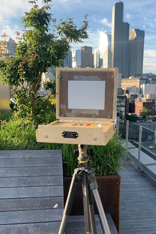 pochade box mounted on a tripod, showing how to travel art supplies