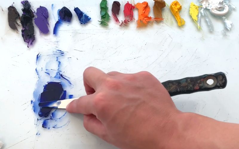 Artist showing color palette how to make dark blue colour